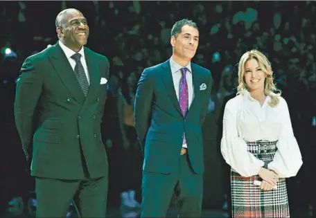  ?? Allen Berezovsky Getty Images ?? MAGIC JOHNSON, from left, general manager Rob Pelinka and Jeanie Buss during happier times with the Lakers in 2017. Johnson quit the team abruptly last month and accused Pelinka of badmouthin­g him. Johnson also said too many people were involved in decisions.