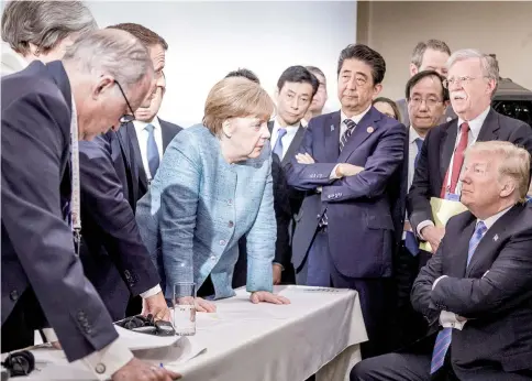  ??  ?? Merkel speaks to Trump during the second day of the G7 meeting in Charlevoix city of La Malbaie, Quebec, Canada. — Reuters photo