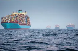  ?? ERIN SCHAFF/THE NEW YORK TIMES ?? Container ships wait to enter the Port of Los Angeles on Oct. 17. Surging inflation and supply chain disruption­s are disrupting global economic recovery.