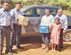  ??  ?? Fijian Competitio­n and Consumer Commission staff hand over food items to Mohammed Imran at Korovou in Labasa on May 5, 2020.