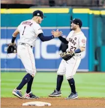  ?? Elsa Garrison Getty Images ?? CARLOS CORREA, left, and Jose Altuve celebrate after the Astros forced a seventh game against the Yankees tonight.