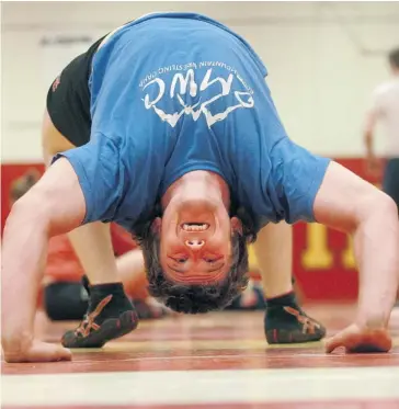  ?? Ted Rhodes/calgary Herald ?? University of Calgary Dinos wrestler Nick Proctor stretches out the kinks before practice Tuesday, the day the Internatio­nal Olympic Committee announced it was dropping wrestling as an Olympic sport.