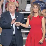  ??  ?? The US President hugs a supporter at a Florida rally, left, which was also addressed by First Lady Melania, above