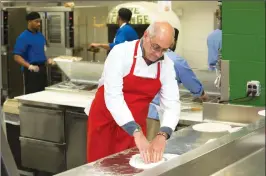  ??  ?? Bruno Abate, a chef/owner of a restaurant in Chicago, teaches inmates about cooking and nutrition at the Cook County Jail in Chicago. Inmate Marcus Clay pulls pizza from oven at the Cook County Jail in Chicago while participat­ing in the jail's “Recipe...