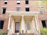  ??  ?? The front entrance of one of two historic apartment buildings under rehab on Lawrence Street. Developer Aaron Gill lives in the neighborho­od with his family and sees the project as part of efforts to chip away at blight in the neighborho­od.