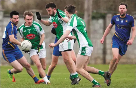  ??  ?? Na Gaeil’s Eoghan Sheehy (no.5) looks to start an attack as Ballymacel­ligott’s Paudie McCarthy, far left, attempts to close him down during their Premier Junior Championsh­ip Round 3 game at Killeen, Tralee on Saturday evening