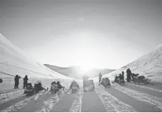  ?? JOHN MCCONNICO, AP ?? A snowmobile tour heads out near Barentsbur­g, Norway, where the cold doesn’t seem to be anything to be unhappy about.