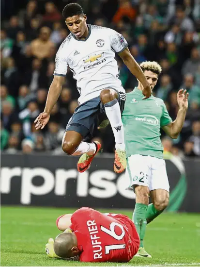  ??  ?? Kept at bay: Manchester United’s Marcus Rashford jumping over St Etienne goalkeeper Stephane Ruffier in the Europa League last 32 second leg on Wednesday.