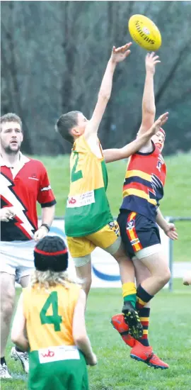  ??  ?? “The big men fly” - Under 12 style - as Garfield’s Joseph Zaccari (left) and Longwarry opponent Cody McInnes share the honours in this ball up during their match at Longwarry on Saturday.