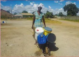  ?? ?? Abigail Mizha pushes a wheelbarro­w with about 80 litres of water. For a fee, Mizha fetches water from the local borehole and delivers it to Mabvuku residents.