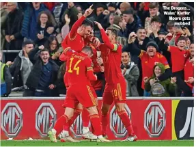  ?? ?? The Dragons… Wales’ Kieffer Moore gets mobbed