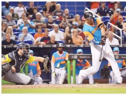  ??  ?? Giancarlo Stanton of the Miami Marlins hits his 50th home run of the season in the eighth inning against the San Diego Padres at Marlins Park on Sunday in Miami, Florida. (AFP)