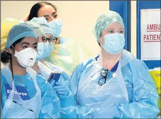  ??  ?? ■
NHS nurses in Personal Protection Equipment (PPE).