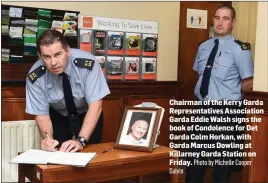  ?? Galvin Photo by Michelle Cooper ?? Chairman of the Kerry Garda Representa­tives Associatio­n Garda Eddie Walsh signs the book of Condolence for Det Garda Colm Horkan, with Garda Marcus Dowling at Killarney Garda Station on Friday.