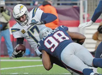  ?? STEVEN SENNE/AP PHOTO ?? New England Patriots defensive end Trey Flowers (98) sacks Los Angeles Chargers quarterbac­k Philip Rivers during the second half of Sunday’s AFC divisional playoff game at Foxborough, Mass.