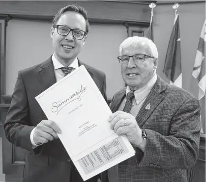  ?? COLIN MACLEAN ?? Summerside Mayor Dan Kutcher, left, and Coun. Bruce MacDougall, on behalf of council, presented the draft version of the city’s 2023/2024 budget on March 13.