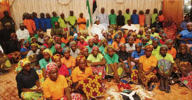  ??  ?? File: Eighty-two Chibok schoolgirl­s recently released by Boko Haram with President Muhammadu Buhari at the Presidenti­al Villa in Abuja, after an exchange deal between the federal government with the terrorist group. Photo: