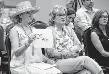  ?? Sue Ogrocki / Associated Press ?? Vicki Toombs (left) handles the timing of speakers at a Democratic Congressio­nal Forum in Edmond, Okla., on May 10. Toombs, 61, said she felt she had to do something after Donald Trump was elected.