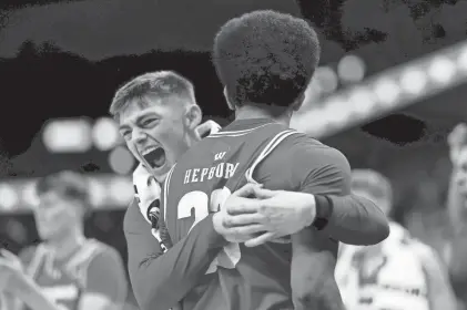  ?? DAVID BERDING / GETTY IMAGES ?? Chucky Hepburn gets a hug from teammate Connor Essegian after his buzzer-beater in regulation sent UW's Big Ten semifinal game against Purdue into overtime on Saturday.