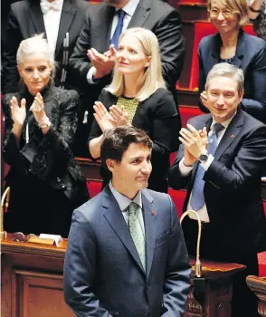  ?? FRANCOIS MORI / THE ASSOCIATED PRESS ?? Prime Minister Justin Trudeau acknowledg­es applause after his speech at the French National Assembly in Paris on Tuesday, the first ever by a Canadian prime minister.