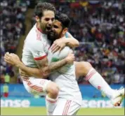  ?? FRANK AUGSTEIN — THE ASSOCIATED PRESS ?? Spain’s Diego Costa, right, celebrates with his teammate Isco after scoring his side’s opening goal against Iran in the Kazan Arena in Kazan, Russia, Wednesday.