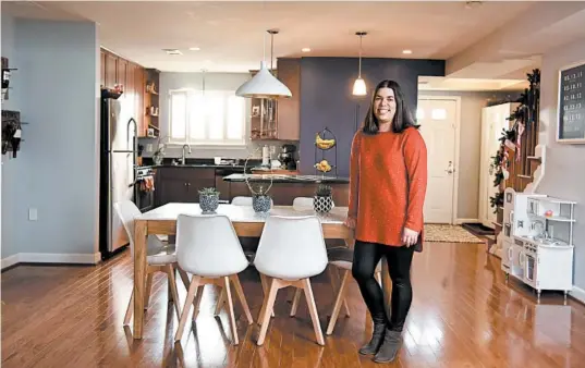  ?? MARVIN JOSEPH/WASHINGTON POST PHOTOS ?? Eliana Kee stands near her kitchen in Arlington, Virginia. She and her husband, Brian, liked that the home, which they purchased for $515,000, was move-in ready.