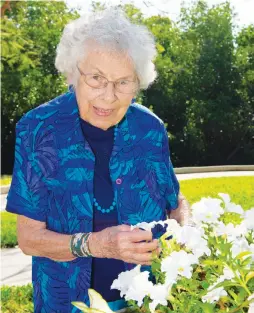  ??  ?? After retiring from a career in the floral industry, Shell Point resident Betty Symes enjoys spending many of her days tending to the flower beds located outside her assisted living apartment at The Arbor.