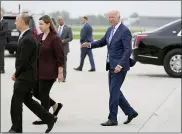 ?? EVAN VUCCI — THE ASSOCIATED PRESS ?? President Joe Biden walks with Rep. Elissa Slotkin, D-Mich., and Lansing Mayor Andy Schor as he arrives at Capital Region Internatio­nal Airport on Tuesday in Lansing.