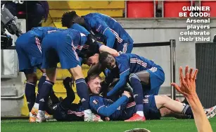  ??  ?? GUNNER BE GOOD: Arsenal players celebrate their third