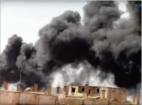  ?? FURAT FM / VIA AP ?? Smoke rises from the Old City in Raqqa, Syria, on Tuesday following heavy bombing. Syrian Democratic Forces fighters, with the aid of U.S. warplanes, breached the ancient wall around the historic neighborho­od as they continued to drive out Islamic...