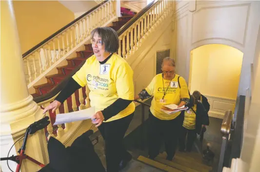  ?? MICHAEL Robinson CHÁVEZ/THE Washington POST ?? Lorrie Rogers, second from left, and other advocates of an endof-life bill climb stairs to visit Maryland Senate offices in Annapolis on Feb. 21.