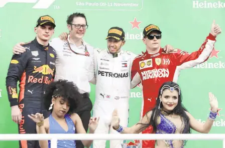  ?? AP ?? The podium: Lewis Hamilton (centre) was gifted the lead and then the win when Max Verstappen (left) spun, while Kimi Raikkonen’s Ferrari rounded off the top three.