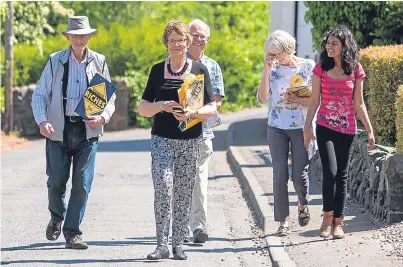  ??  ?? The Liberal Democrats’ Elizabeth Riches, centre, gets some help as she canvasses in Newburgh.