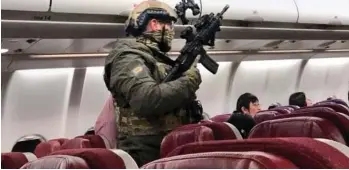  ??  ?? Lockdown: Armed officers stormed the plane after it was forced to turn back