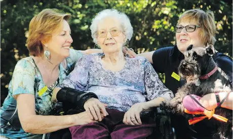  ?? JULIE OLIVER ?? Evelyn Dick, who is 101 years old, was recently hit with a towel by a caregiver at the local long-term care home where she lives. She is pictured outside the home with her two daughters, Margaret Anthony, left, and Rosemary Murray, and Rosemary’s dog, Gypsy.