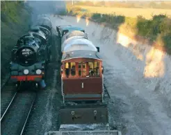  ?? TOBY JENNINGS/SR ?? The scale of chalk excavation for a new siding east of Ropley is clearly visible as visiting BR ‘4MT’ 2‑6‑4T no. 80078 pilots resident ‘Schools’ 4‑4‑0 no. 925 Cheltenham down the bank from Medstead &amp; Four Marks, during the Mid‑hants Railway’s Autumn Steam gala on october 20.