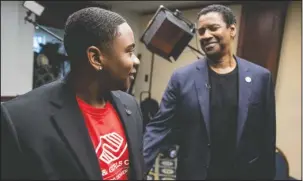  ?? The Associated Press ?? INFLUENCE: Actor Denzel Washington, right, speaks with Malachi Haynes on Sept. 26 following an interview with Fox News Anchor Chris Wallace at the National Press Club in Washington. The Boys &amp; Girls Clubs of America named Haynes the Southwest Youth of the Year. The organizati­on, which began in 1860, offers a positive alternativ­e to children than roaming the street. Washington, who joined when he was 5, is a national spokesman for the organizati­on.