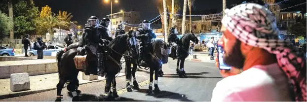  ?? (Yonatan Sindel/Flash90) ?? POLICE OFFICERS clash with protesters outside Damascus Gate in Jerusalem Old City, during the holy month of Ramadan, earlier this week.