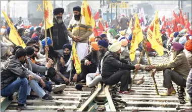  ?? Photo: AFP ?? Farmers block railway tracks during a four- hour rail blockade as they continue their protest against the central government’s recent agricultur­al reforms, at a railway station in Amritsar, India on Thursday. Authoritie­s deployed thousands of security forces at railroad stations and tracks to prevent violence.