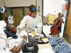  ?? TOM SAMPSON/AP ?? Cellist Martha Vance plays for a patient at Medstar Georgetown University Hospital in Washington DC. Musicians and dancers are part of the Georgetown Lombardi Comprehens­ive Cancer Center’s arts and humanities program.