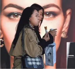  ?? ANDY WONG/AP FILE ?? Women visit a Beijing shopping mall. China seems unique in showing economic growth in 2020, due in part to early pandemic recovery efforts.