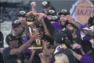  ?? MARK J. TERRILL — THE ASSOCIATED PRESS ?? The Lakers celebrate after defeating the Heat, 106-93, in Game 6of the NBA Finals on Oct. 11in Lake Buena Vista, Fla.