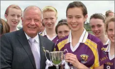  ??  ?? Elsa McDermott receiving the trophy from Pat Quill.