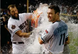  ?? ASSOCIATED PRESS ?? AFTER PUTTING DOWN A SACRIFICE BUNT in the ninth inning, Arizona Diamondbac­ks’ A.J. Pollock (11) gets doused with water by teammate Steven Souza Jr. (left) after Tuesday’s game against the Los Angeles Angels in Phoenix. The Diamondbac­ks defeated the Angels 5-4.
