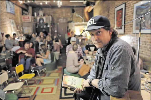  ?? BOB ANDRES /BANDRES@AJC.COM ?? Matt Arnett at Grocery on Home on show night. Matt lives in the converted corner store in Grant Park where he occasional­ly hosts concerts for 60 guests who RSVP on the Grocery on Home Facebook page. The son of art collector Bill Arnett, Matt took what...