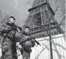  ?? BENOIT TESSIER/REUTERS ?? French soldiers patrol at the Eiffel Tower on Monday in Paris. France raised its terror alert to its highest level following Friday’s shooting in Moscow.