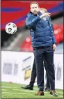  ??  ?? England manager Gareth Southgate throws the ball back onto the pitch during the UEFA Nations League soccer match between England and Denmark at Wembley stadium in London,
England on Oct 14. (AP)