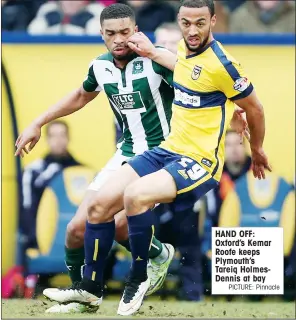  ?? PICTURE: Pinnacle ?? HAND OFF: Oxford’s Kemar Roofe keeps Plymouth’s Tareiq HolmesDenn­is at bay