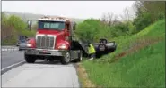  ?? MARIAN DENNIS — DIGITAL FIRST MEDIA ?? A black Nissan sedan flipped on Route 422 West is towed from the scene of a one-vehicle crash.