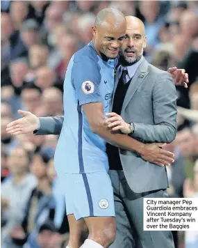  ??  ?? City manager Pep Guardiola embraces Vincent Kompany after Tuesday’s win over the Baggies